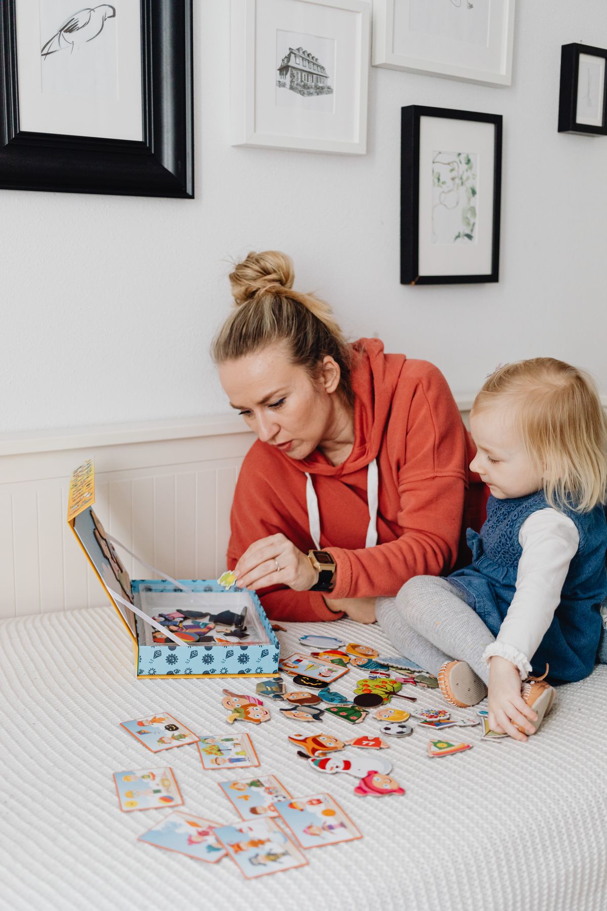 A mother and child sharing a book and a playful activity